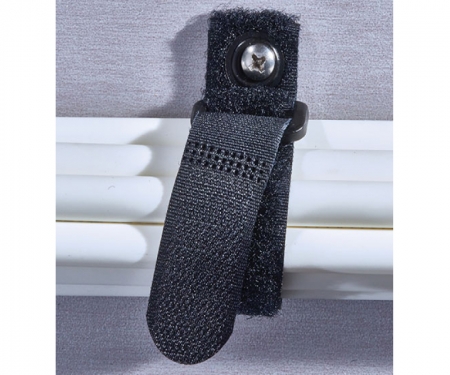 Black cinch strap used to hand white cables