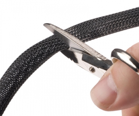 Clean Cut PET sleeving being cut with scissors