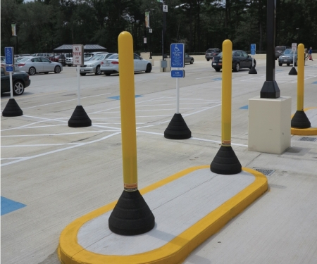 yellow plastic bollard post with black rubber base in use in parking lot yellow plastic bollard post with black rubber base in use in parking lot