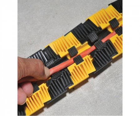 Cords being inserted in Sidewinder floor cord cover Cords being inserted in Sidewinder floor cord cover